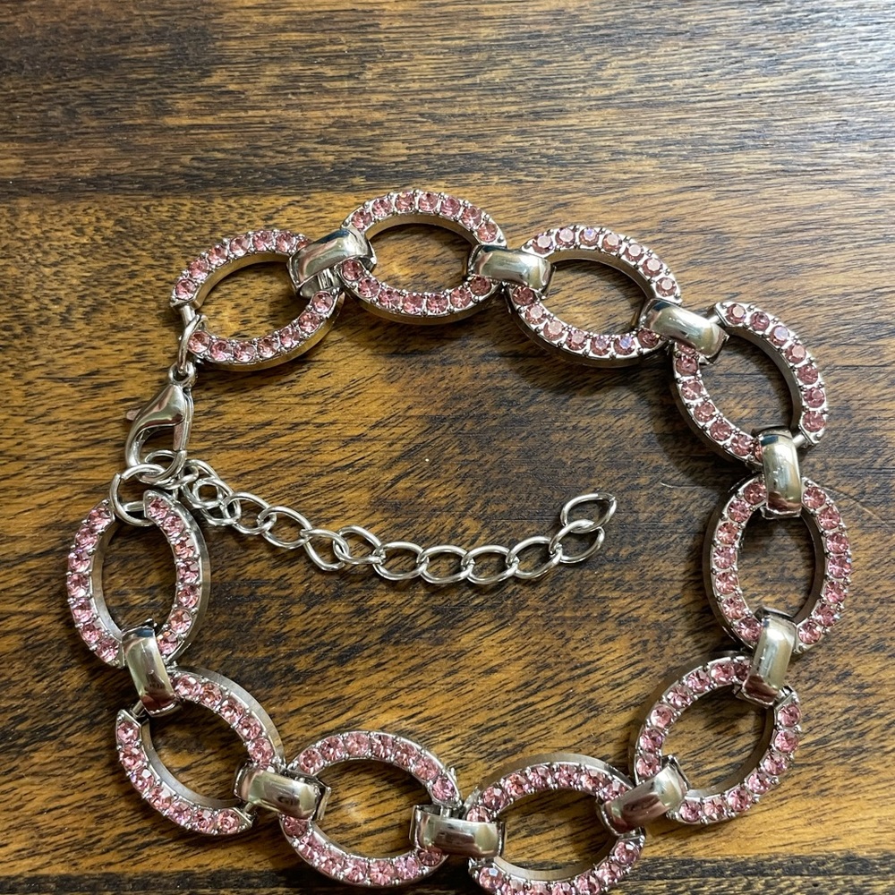 Beautiful silver-tone bracelet with pink rhinestones measuring 7"